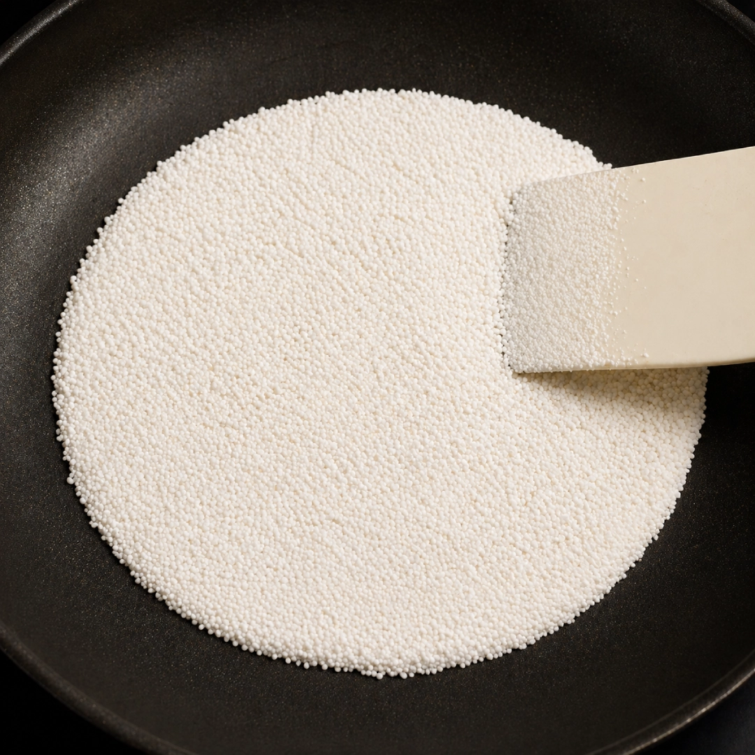 Tapioca starch being spread in a hot non-stick pan